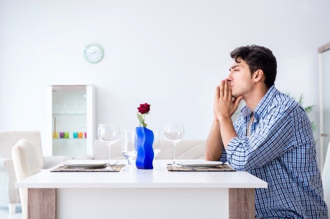 MP 410 Email Image 1 man sitting alone at table with single rose