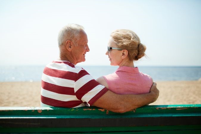 MP 410 - MP 410 Email Image 2 old couple sitting on a bench at the beach