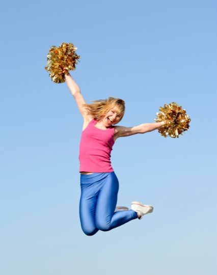 cheerleader jumping with pom poms