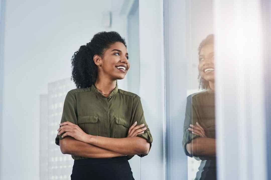 woman smiling into a mirror