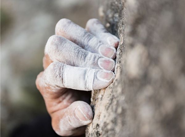 fingers of a rock climber grasping rock