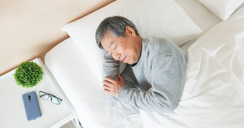 old man sleeping in bed